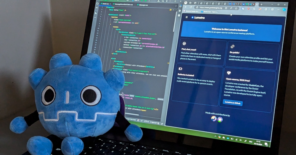 A Godot mascot plush next to a laptop displaying Project Lumetra
